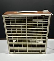 Front view of vintage Torcan box fan showing cream safety grille and 'Torcan' brand name plaque.
