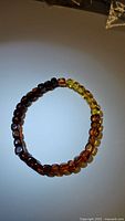 Top view photo of the Baltic amber bracelet showing gradient color from dark brown to yellow beads.
