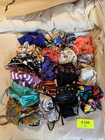 Pile of 18 assorted bikini tops and bottoms laid out, various patterns and solids visible
