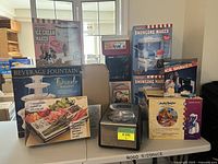 Overview of boxed beverage fountain, ice cream makers, projector box, Cuisinart machine, snowcone maker, ice shaver and Arctic Twister mixer