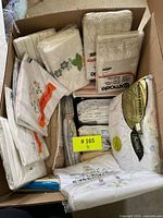 Cardboard box containing various packaged bed linens