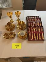 Overview of entire tea service: goblets, cups, saucers, sugar bowl, creamer and flatware box