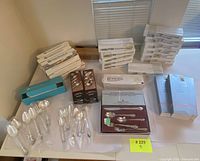 Overview of multiple branded cutlery and serving boxes arranged on table