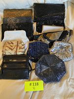 Top view showing the collection of multiple vintage evening purses and bags of various styles and colors arranged together.