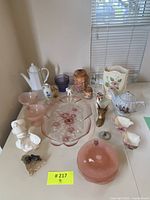 Full view of all items loosely arranged on table showing variety of vintage decorative and kitchen pieces