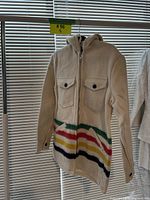 Front view of cream hooded jacket with stripe pattern and flap pockets