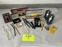 Overview of 16 vintage wristwatches and accessories laid on table