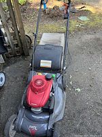 Front view of mower showing deck, engine cover and grass bag