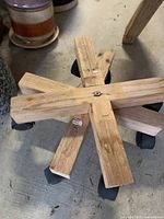 Wooden rolling plant stand with caster wheels visible