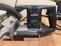 Porter Cable Model 556 plate joiner showing overall tool body, handle, and base plate on wood surface.