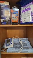 Shelf with Oral-B Pro 500 toothbrush box, Gillette Proglide Styler package, and large bag of Lavender Epsom Salt
