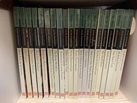 Shelf of 20 Woodsmith Custom Woodworking books by Time Life showing titles like 'Shop Built Toy & Patterns', 'Bedroom Shelves & Cabinets', 'Outdoor Projects Deck Lawn & Garden'