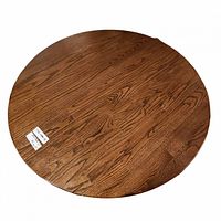 Top view of the round wooden table showing the wood grain and finish.