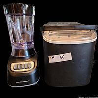 Black ice maker with clear lid next to the blender.