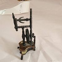 Front angled view of the vintage cast iron pencil sharpener showing detailed castings and the crank wheel.