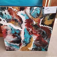 Abstract resin on metal wall art with swirling patterns of turquoise, brown, black, white and gold, square 20x20 size