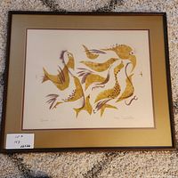 Framed art print with stylized gold and brown birds, matted and framed, lying on carpeted floor, showing overall condition and size.