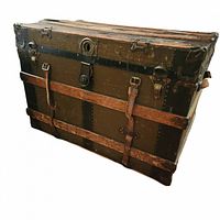 Front view of the large WW1 travel steamer trunk showing metal banding, leather straps and lock hardware.