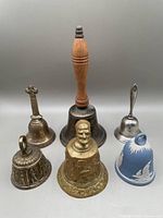 Overview of all 6 vintage bells showing varying materials and motifs