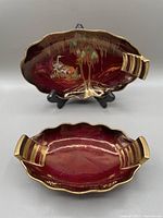 8.5 inch Carleton Ware Rouge Royale oval dish showing enamelled cranes and willow tree design with gold accented scalloped edges and handle
