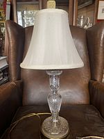 Full lamp with fabric shade on a leather chair