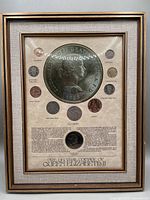 Framed set showing all 12 pre decimal British coins and printed description, mounted on fabric matt in wooden frame with glass.