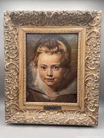 Full view of the framed canvas print showing a portrait of a child with an ornate gold frame.