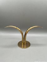 Front view showing dual curved brass upward petal design resembling lily flowers.