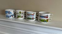 Eight stacked Campbell Soup ceramic soup bowls showing different outdoor scenes with children