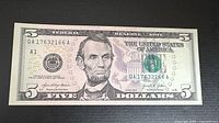 Front view of the uncirculated $5 bill showing serial number QA17632166A and Abraham Lincoln portrait.