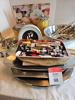 Full view of serving trays, decorative plate, salt and pepper shakers, and yellow containers.