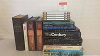 Stack of 13 coffee table books including titles on art, history, and culture.