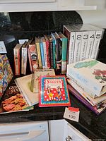 Assorted cookbooks and recipe holder on countertop