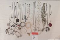 Full lot on white background showing necklaces at top, rings and bracelets at bottom