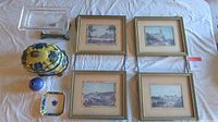 Four French building scene prints framed, along with various decorative ceramic and glass items including a bud vase, decorative pot with lid, Takahashi dish, and German lead crystal dish.