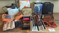Full view of all items including T3 hairdryer, makeup brush sets in cases, Panasonic Arc 3 shaver stand box, Wahl trimmer with accessories, nail kits in leather cases, and bathroom organizers.