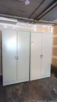 Front view of two closed cabinets against wall