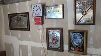 Wide view showing all six framed signs on a wall including the Coca-Cola clock and red Coca-Cola sign below it.