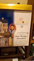 Box front showing Elvis Presley Graceland image and gift set details including lighted building and 1955 pink Cadillac model.
