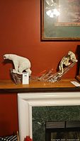 View of both polar bear and cheetah figurines on shelf showing overall condition and scale.