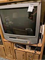 Front view of Sylvania 27-inch TV/VHS/DVD combo unit showing the CRT screen and integrated player consoles.