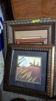 Stacked view of three framed scenery prints showing detailed frame textures and wheat field print