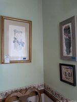 Three framed wall art pieces hung on a wall, showing their relative sizes and framing.