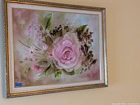 Frontal photo of the framed floral painting showing flowers and signature.