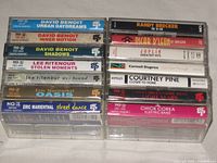 Stacked spines of all 14 cassettes showing artists and titles