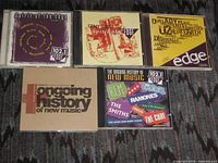 Front view of all five CFNY compilation CDs