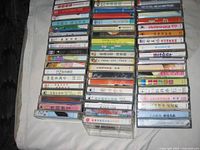 Top-down view of two columns of stacked Chinese cassette tapes showing paper sleeves and spines