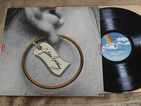 Front album cover and vinyl record on right showing rainbow MCA label