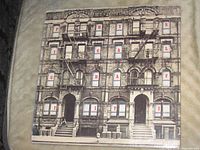 Front of die-cut outer jacket with PHYSICAL GRAFFITI lettering