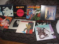 Front covers of nine visible records on sofa